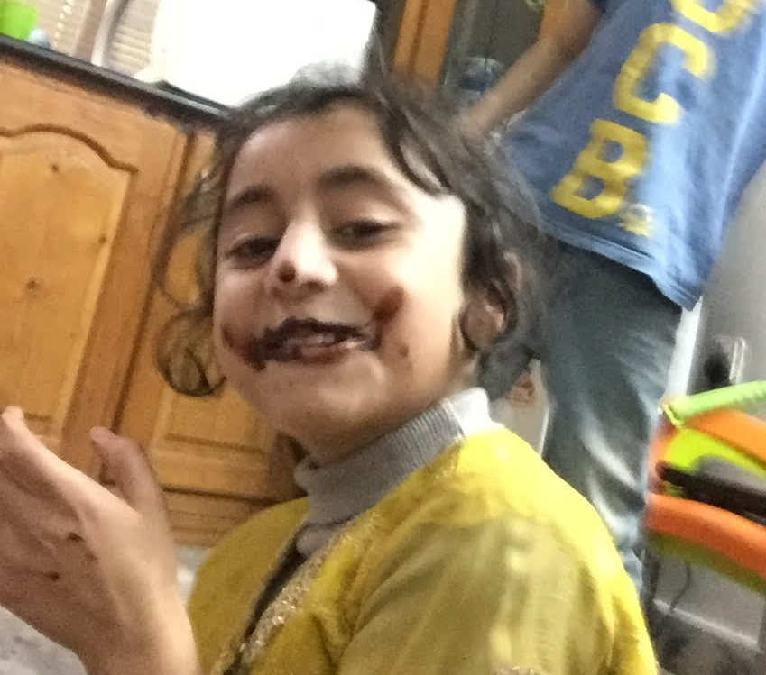 happy kids eating chocolate doughnut